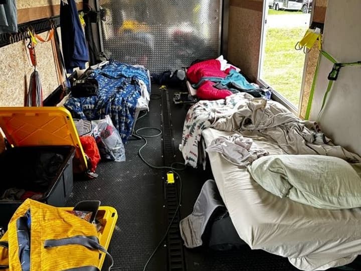 By night, the enclosed trailer became a compact three-person bunkhouse.